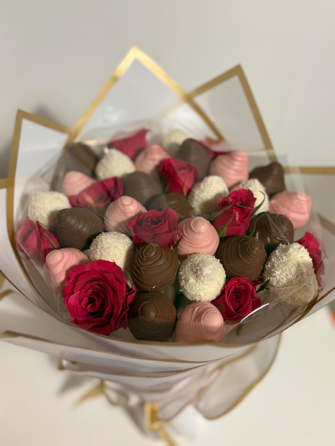 Elegant bouquet of chocolate-dipped strawberries and red roses