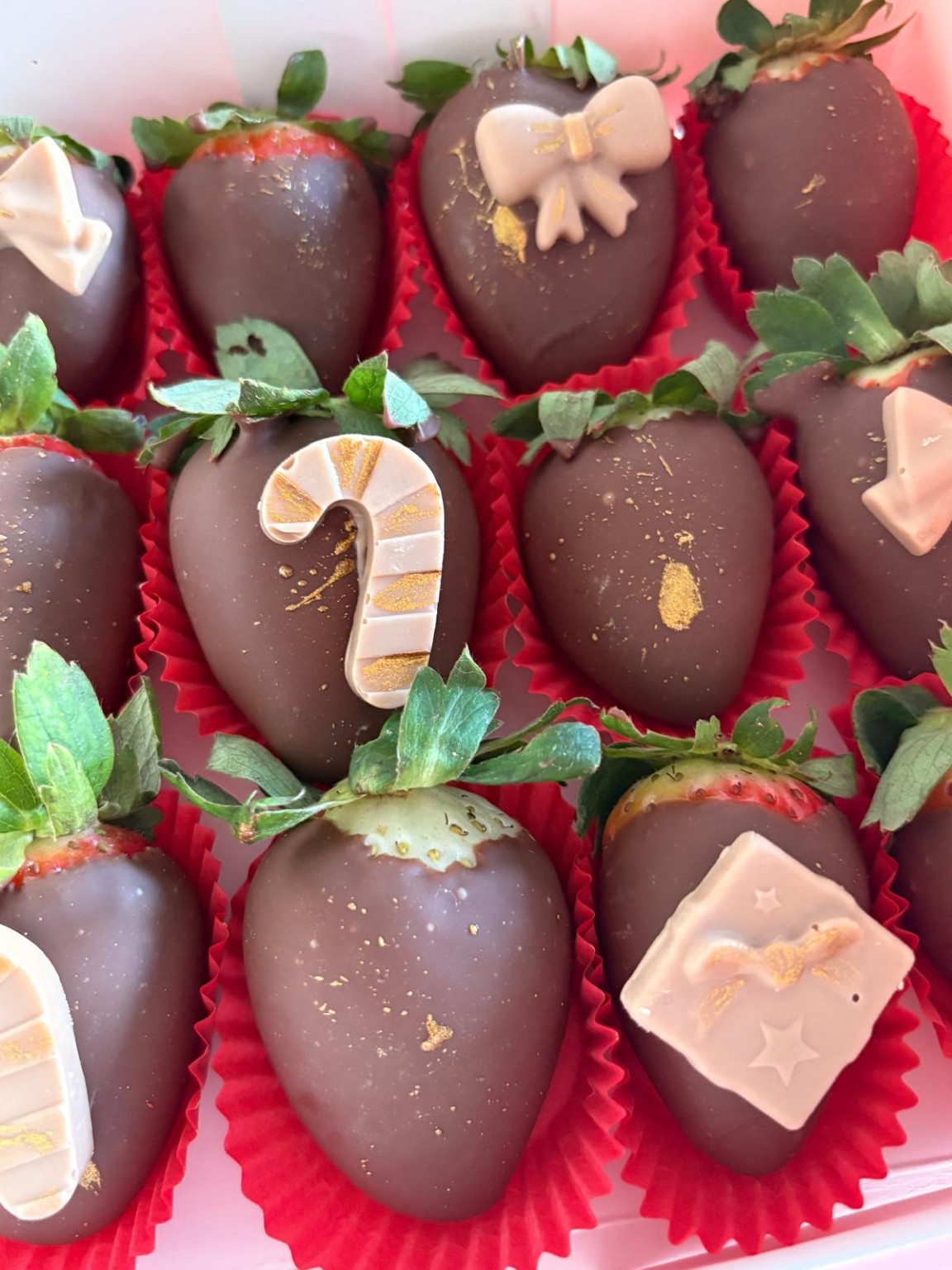 Christmas strawberry box with candy cane, bow and gift decorations