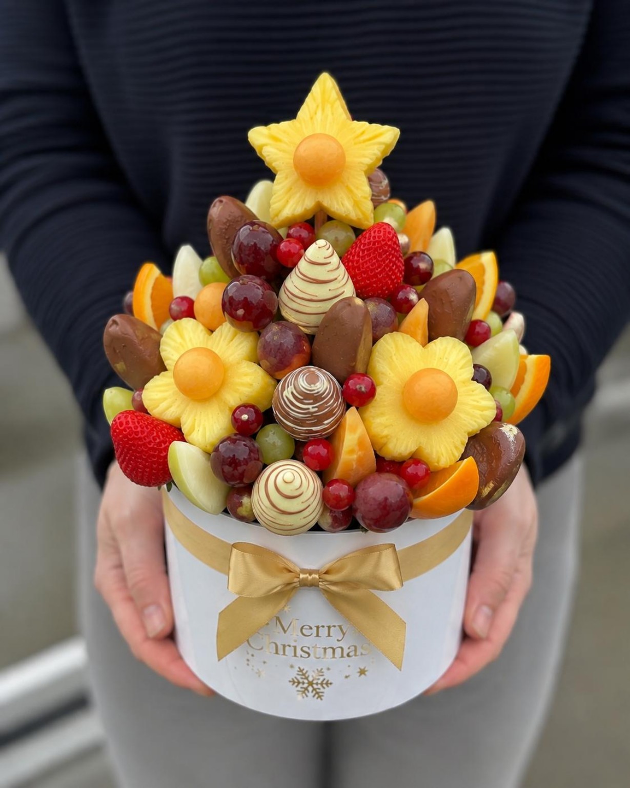 Fruit bouquet arranged in a decorative hatbox