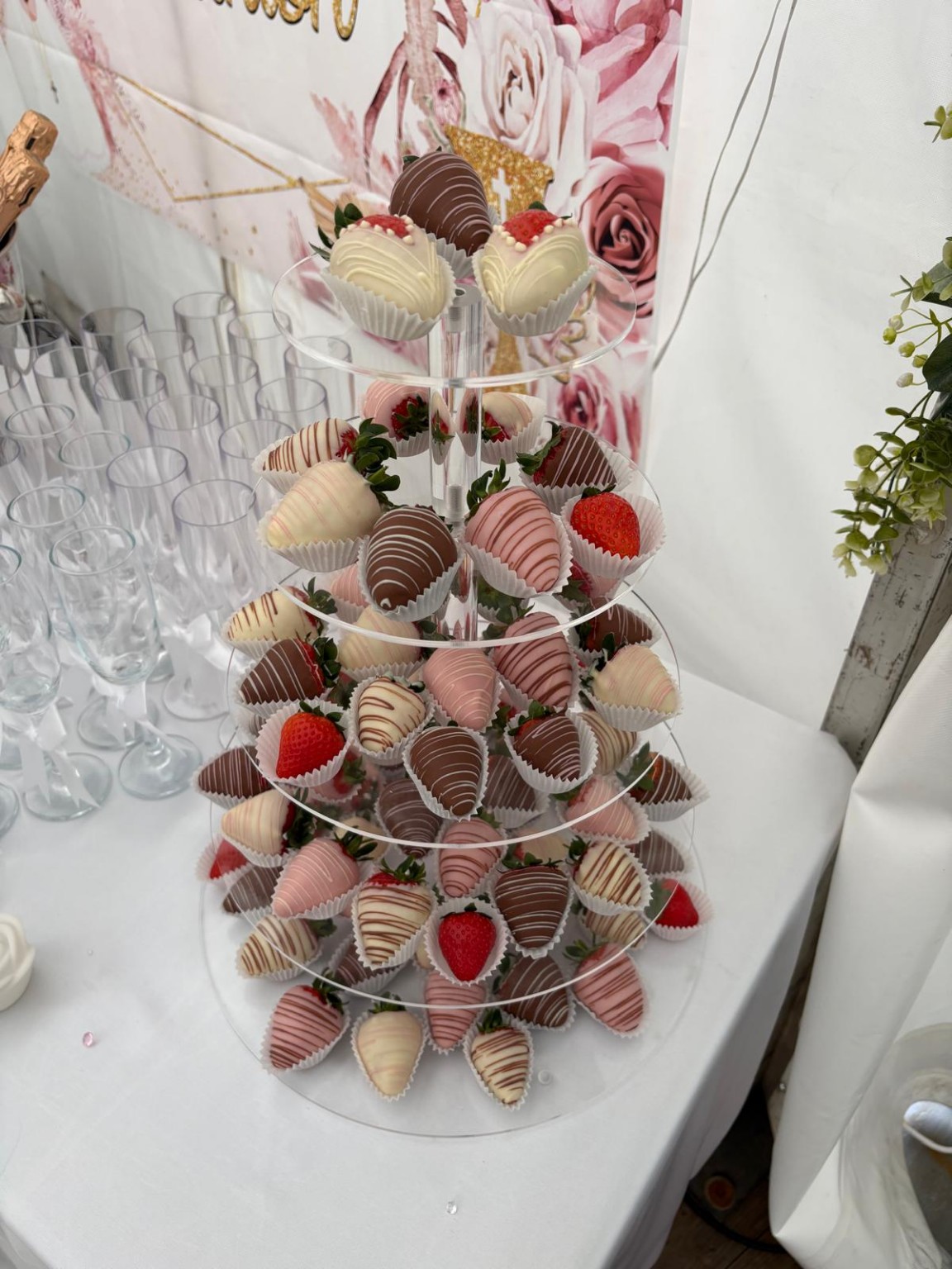 Ivana’s chocolate strawberry tower displayed on a clear tiered stand at a celebration